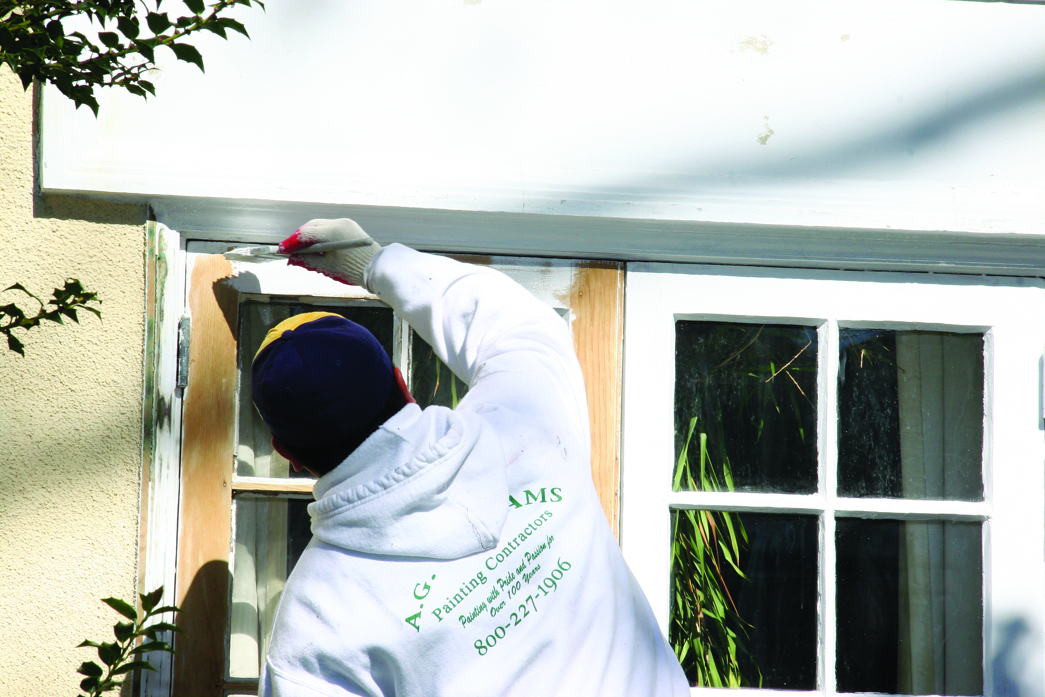 A.G. Williams painter working on an exterior detail
