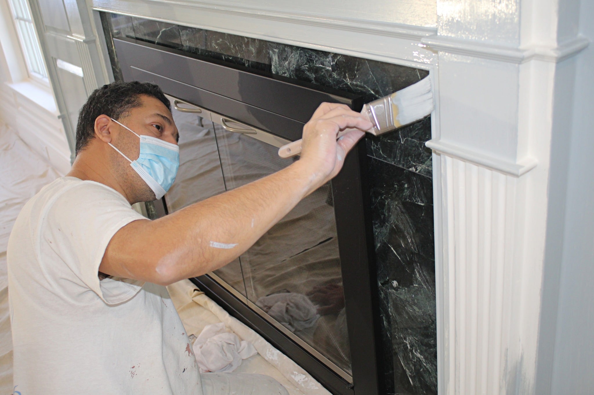 A.G. Williams painter working carefully on interior trim