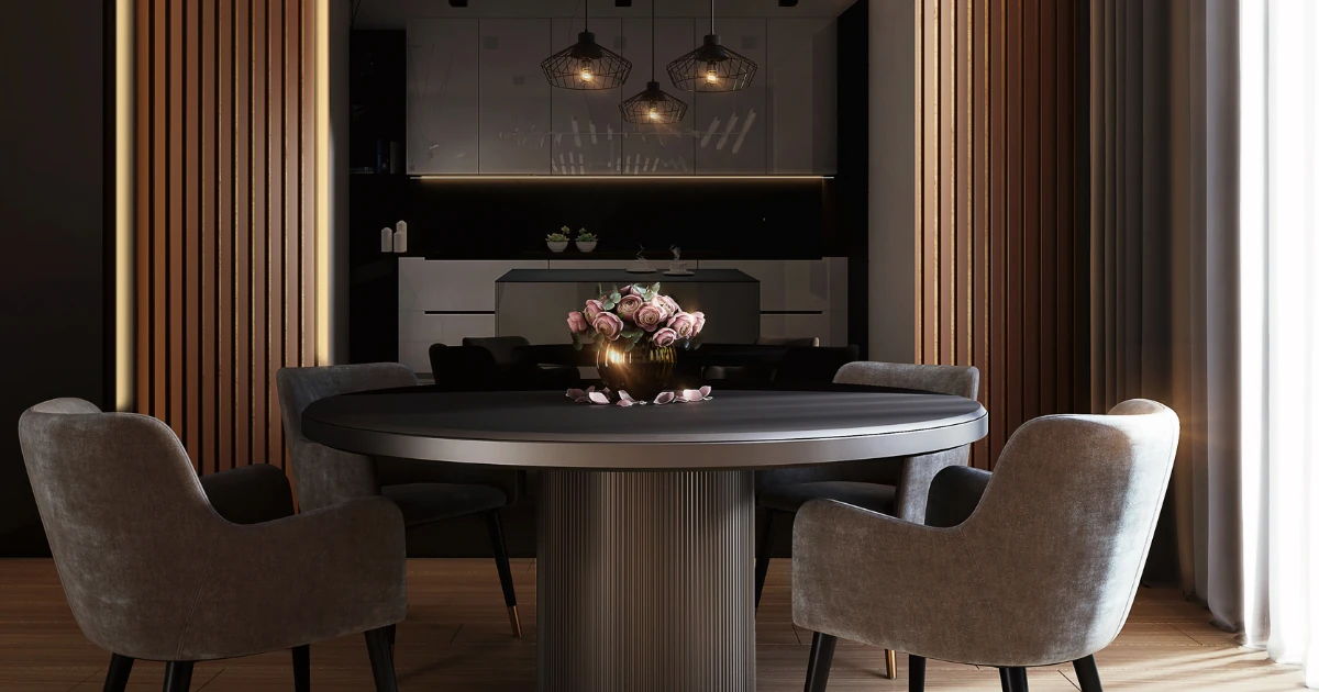 A moody modern dining room with a round dark table, gray velvet armchairs, wood-slat panel walls, geometric wire pendant lights, and pink roses as a centerpiece.