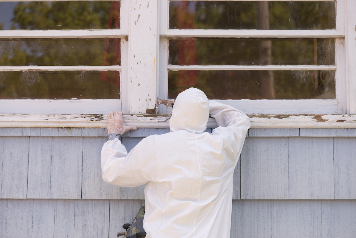 Exterior painting prep detail with protective work around trim.