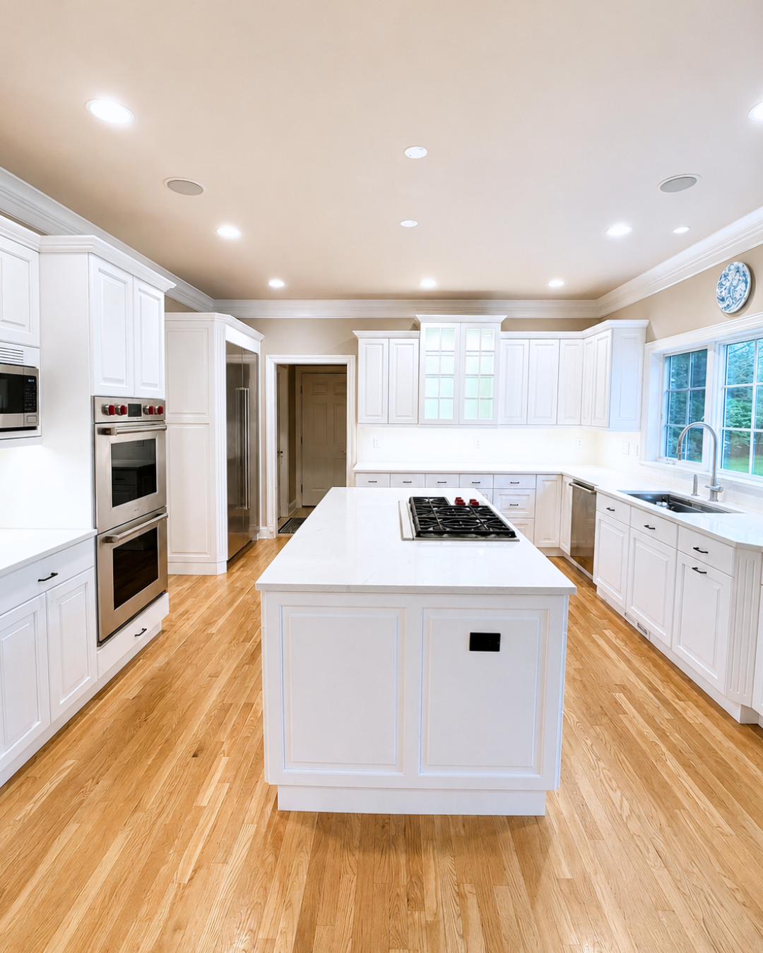 Same Stamford kitchen after refinishing, with updated cabinet finish and island.
