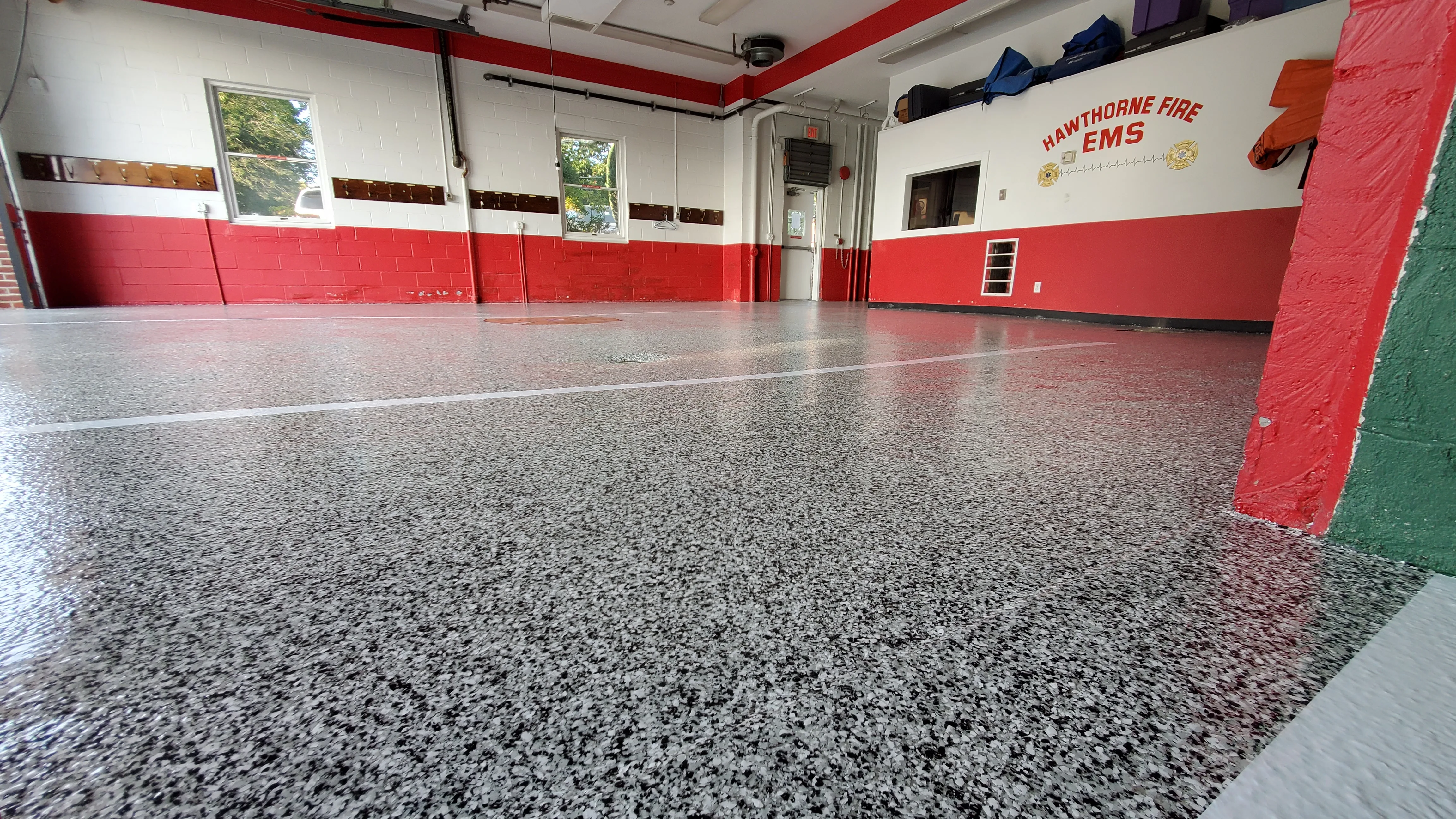 Commercial firehouse floor coating project in progress.