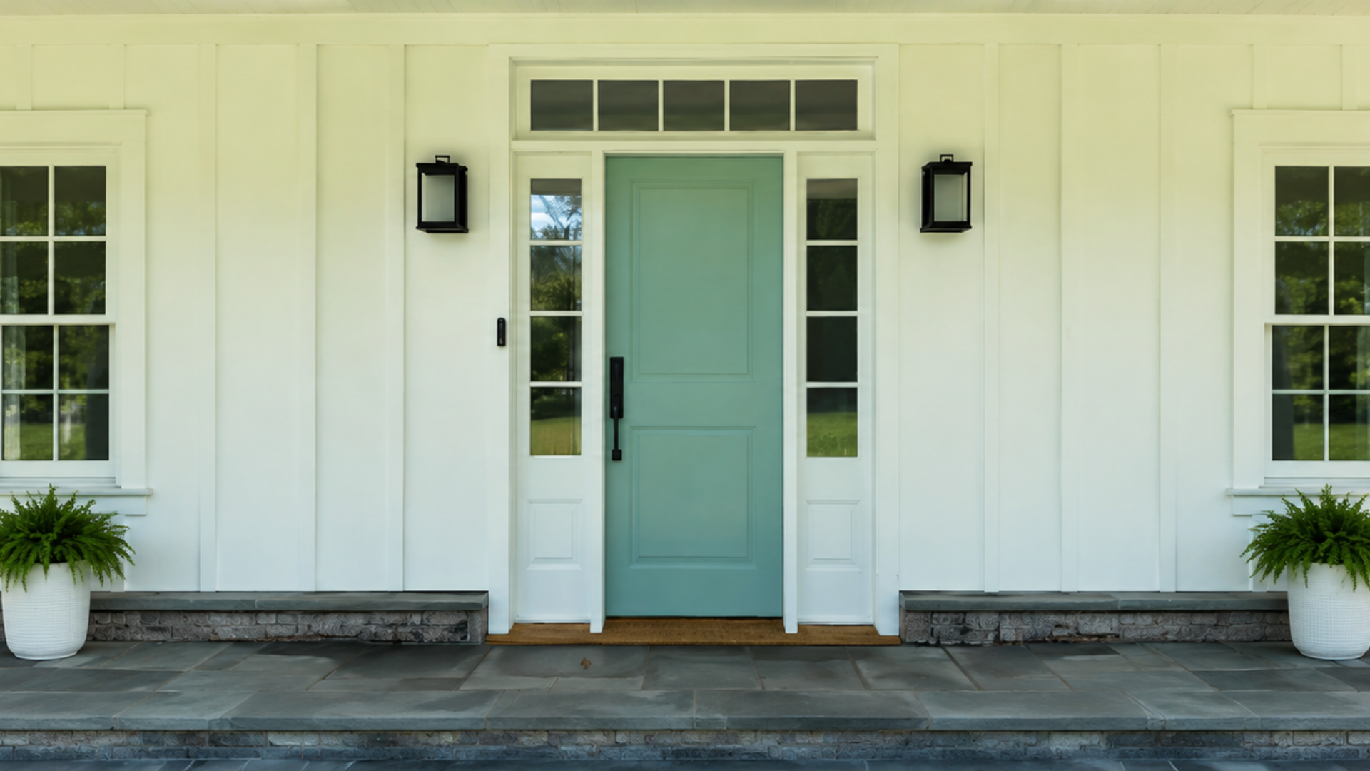 White home exterior with a glossy aqua front door for the A.G. Williams summer front door upgrade special.